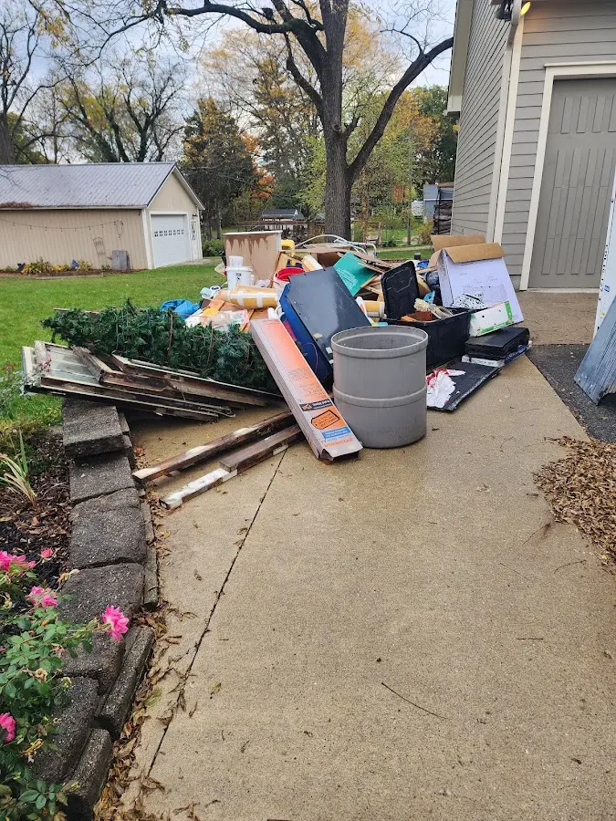 Dumpster being loaded with debris for 10 Yard Dumpster Rental in Hiawatha